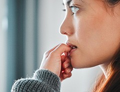 Closeup of woman biting her nails