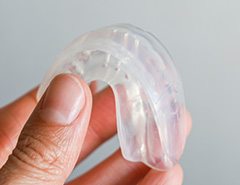 Patient holding clear mouthguard