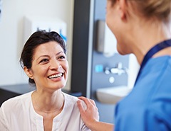 Patient in Newark discussing implanted dentures with dentist