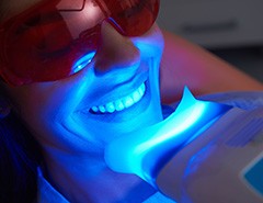 Closeup of woman having teeth whitening in office