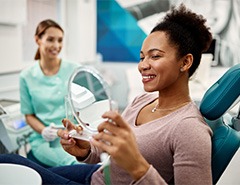 Woman smiling at reflection in mirror